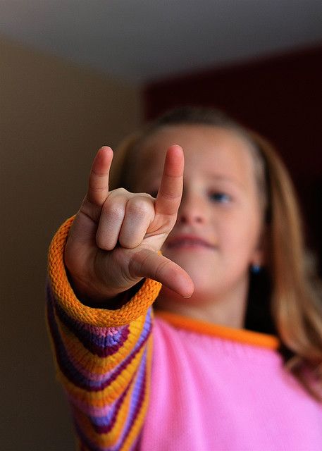 child making an ASL sign