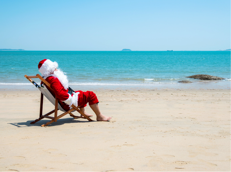 Santa sitting on a chair on the beach